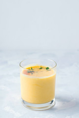 lassi drink mango on a gray concrete background with place for tex