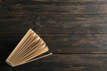 Book on wooden background, top view. Self-development
