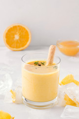 lassi drink mango closeup on a light concrete background. Milk smoothie