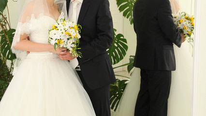 Bride holding the wedding bouquet, with succulent flowers, close-up