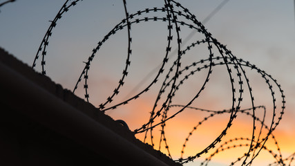 Sunset behind the barbed wire along the border. Sochi, Russia.