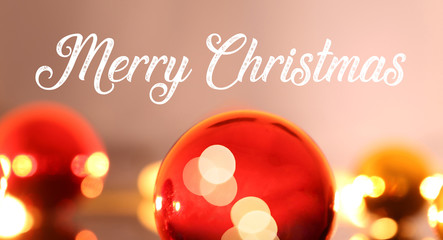 Christmas greetings with english text „merry christmas“ and Christmas baubles
