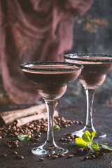 glasses of cream coffee cocktail or chocolate martini on black background