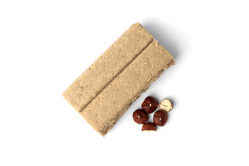 Halva and hazelnut isolated on white background.