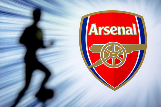 LONDON, ENGLAND, JULY. 1. 2019: Arsenal Football club logo, Premier League, England. Soccer player silhouette.