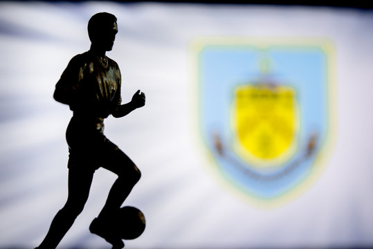 LONDON, ENGLAND, JULY. 1. 2019: Burnley Football club logo, Premier League, England. Soccer player silhouette.