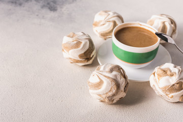 cup of hot coffee with milk and aromatic spices and sweet marshmallows and cookies for a good...