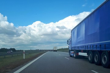 Loaded European truck transporting cargo. Truck on asphalt road. Logistic and transport concept.