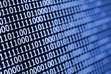 Macro shot of binary code on the monitor of an office computer. The concept of the programmer's work. The flow of digital information strings. phantom classic blue color