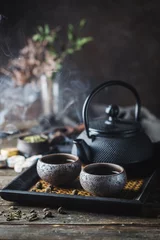 Foto op Aluminium Still-life of japanese healthy green tea in a small cups and teapot over dark background © petrrgoskov