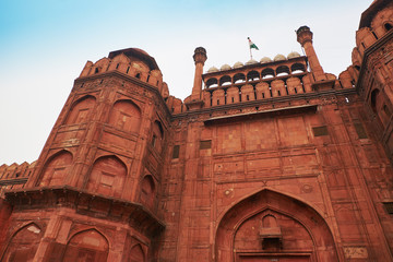 Red Fort or Lal Qila in Delhi, India. Ancient Fort made of red sandstone with India flag on top. Architecture of India