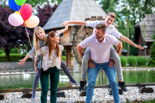 Mom, Dad And Their Kids Goofing Around