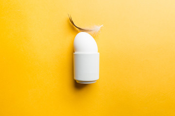 White egg on the yellow background in center. Pop art design minimalism style