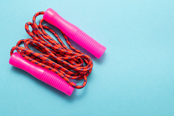 Pink rope on blue background.Sports, fitness and healthy lifestyle concept.