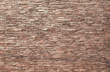 The background image of the wall decorated with small pieces of brown stone.