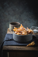 Brushwood - russian traditional cookies with powdered sugar. Plate with hvorost on wooden table