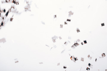 Falling solver confetti on neutral grey backdrop.