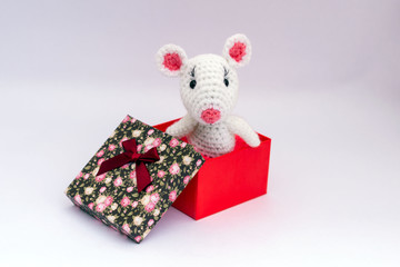 A gift from the heart of a colored cardboard box with a lid.