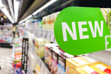 New word signage on supermarket shelf for new product arrival