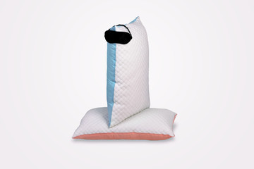Personified quilted pillows with sleeping mask on gray background. Soft cushion for comfortable sleep and sweet dreaming