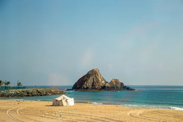 marquee by the ocean and rock in the water
