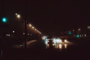 Car light in foggy Berlin night