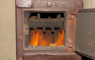 The fire burns in the stove winter home heating concept