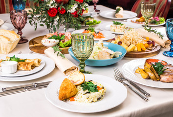 Kiev-Style Cutlet with Breadcrumbs at the banquet table. European food in a restaurant setting. Kiev-Style Cutlet in White Creamy Sauce with rice, cordon bleu chicken cutlet, snack. Table set 