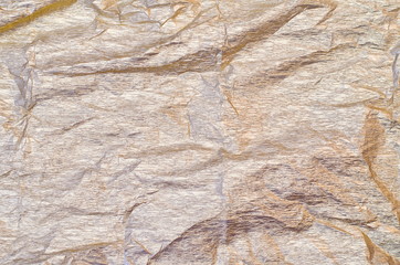 Background of silver and golden crepe tissue paper