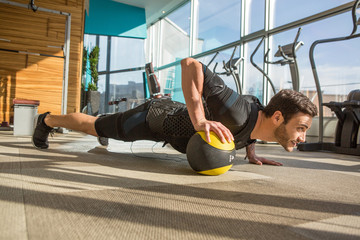 Man doing electro muscular stimulation training in a modern gym