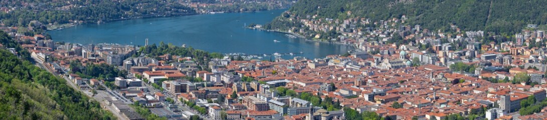 Fototapeta na wymiar Como - The panorama of the city among the mountains and lake Como.
