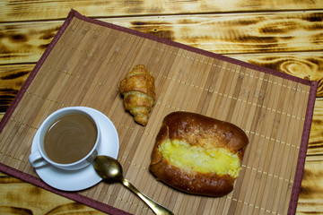 coffee with pastries and a croissant, top view, selective focus