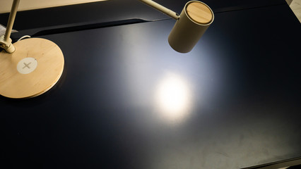 A working blue table, a table lamp on top.