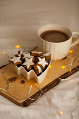 Christmas cookies stars, cocoa on a wooden board.