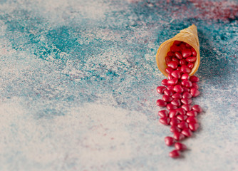 Heart shaped pink sugar candies and waffle cone on pink and aqua colors background. Copy space