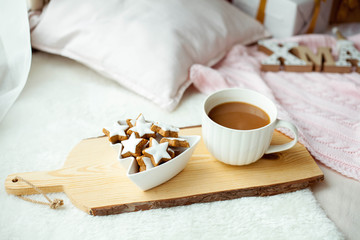 Christmas cookies stars, cocoa on a wooden board. Christmas decor, candles, plaid.