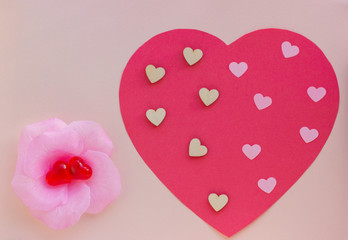 Hearts on a pink background. Valentin's Day, top view. Copy space. Flat lay. Greeting card.