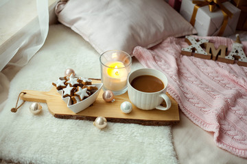 Christmas cookies stars, cocoa on a wooden board. Christmas decor, candles, plaid.