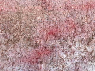 Texture of iron metal painted bright paint peeling paint old battered scratched cracked ancient rusty metal sheet wall with corrosion. The background.