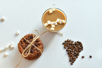 cocoa, marshmallows, homemade cookies and heart made from coffee beans on a white background