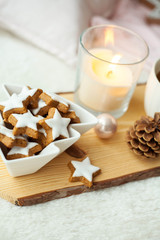 Christmas cookies stars, cocoa on a wooden board. Christmas decor, candles, plaid.