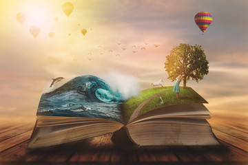Concept of an open magic book; open pages with water and land and small child. Fantasy, nature or learning concept, with copy space - obrazy, fototapety, plakaty
