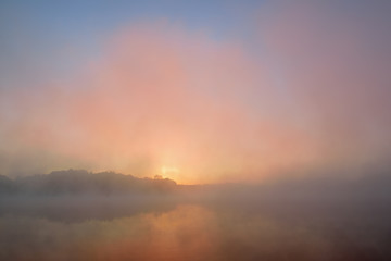Fototapeta na wymiar Autumn sunrise Whitford Lake in fog, Fort Custer State Park, Michigan, USA