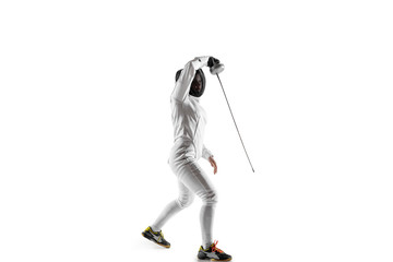 Fototapeta premium Teen girl in fencing costume with sword in hand isolated on white studio background. Young female caucasian model practicing and training in motion, action. Copyspace. Sport, youth, healthy lifestyle.