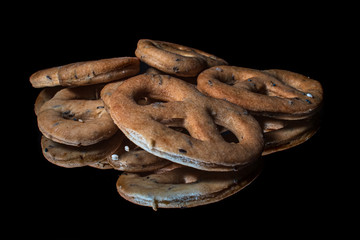 Homemade whole grain snacks with reflection on shiny black background