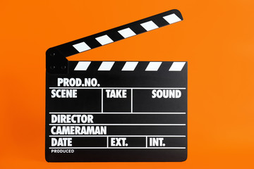 Clapper board on orange background. Cinema production