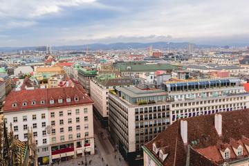 View of city, roofs of houses and skyline mountains Alps from St. Stephen's Cathedral, Vienna, Austria