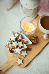Obraz na płótnie Canvas Christmas cookies stars, cocoa on a wooden board. Christmas decor, candles, plaid.
