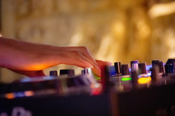 hand on dj mixing console