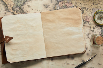 top view of vintage blank notebook with fountain pen near compass on map background - obrazy, fototapety, plakaty